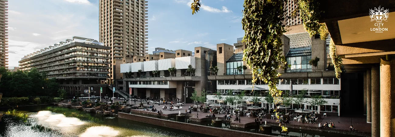 The Barbican Centre with a lake and terrace in the foreground.