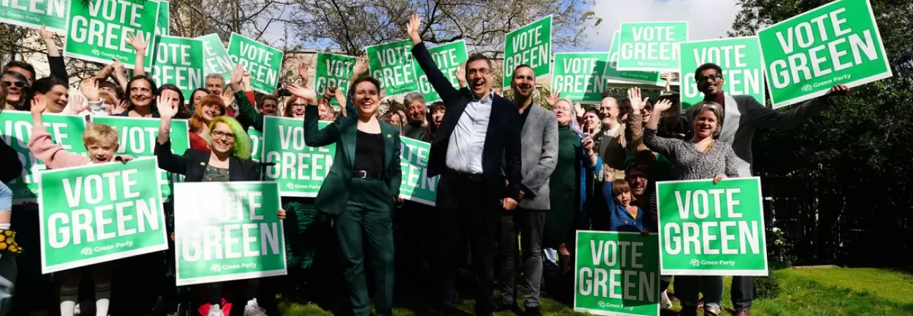 A group of Green Party candidates holding party placards.